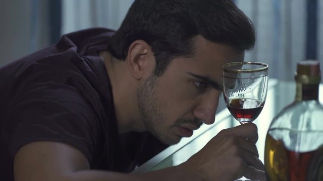  man alone is drunk drinking red wine