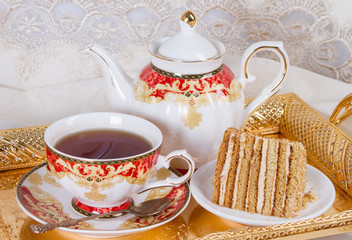 Tea and a slice of cake with cream filling