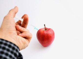 Red apple with syringe