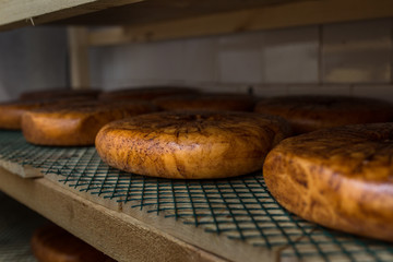 cheese at the dairy, cheese is ripen on racks