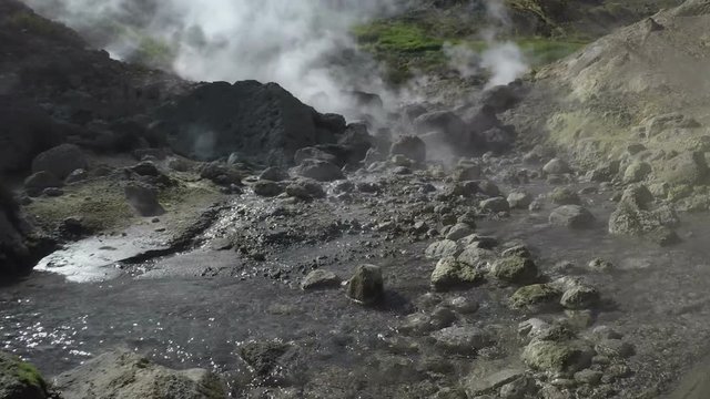 Kamchatka Peninsula, Dachnye Hot Springs located at foot of active Mutnovsky Volcano: geothermal field, activity of natural volcanic hot springs - hot gas, steam and flowing stream with thermal water.