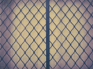 Closeup image of an aluminum window and iron mesh. Retro effect.