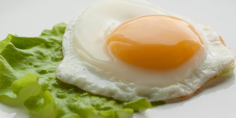 Fried eggs with green leaf lettuce