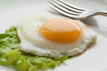 Fried eggs with green leaf lettuce