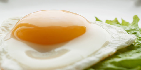 Fried eggs with green leaf lettuce