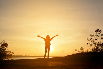 Silhouette of happy women relax in the nature concept travel at the sunset 