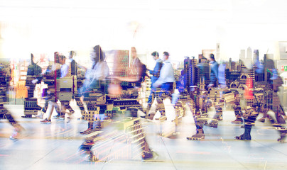 Silhouettes of business people walking in London against of sunset. Multiple exposure image....