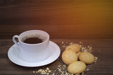 coffee cup and cookie on wooden background