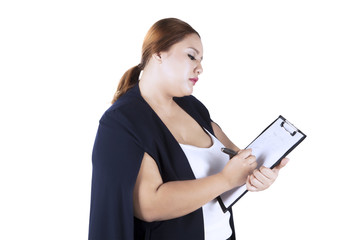 Blonde woman writing on clipboard