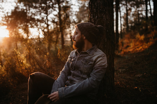 Man having peaceful time in the forest at sunset