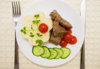 Pieces of braised liver with mashed potatoes on the side top view