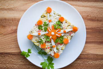 Salad of boiled chicken with boiled carrots, potatoes, egg and cucumber top view