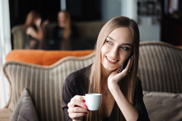 a woman with cute smile having mobile phone conversation while r