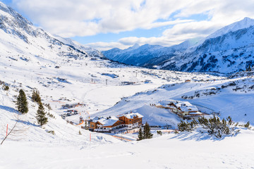 Fototapeta na wymiar View of mountain huts covered with fresh snow in Obertauern winter resort, Austria