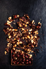 Chopped Nut Chocolate bar background on black  / Dark crushed ch