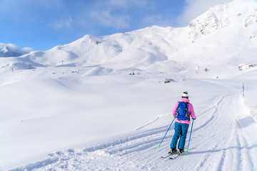 Fototapeta na wymiar Young woman skiing on ski slope in Obertauern, Austria