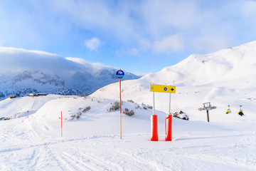 View of ski slopes in Obertauern ski area on sunny winter day with beautiful clouds, Austria