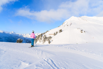 Naklejka na ściany i meble Young woman skier looking at mountains in Obertauern ski area, Austria