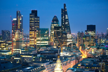 City of London at sunset with lights and reflection. View at the business and banking aria with modern skyscrapers 