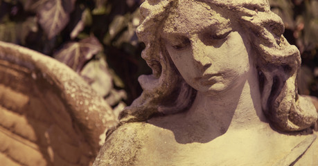 Beautiful close up af a face angel stone sculpture with a sweet