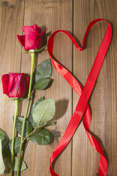 Roses and Ribbon on top of the wood heart shaped