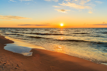 Fototapeta na wymiar Sunset over sandy beach in Leba, Baltic Sea, Poland