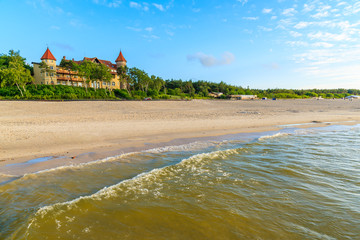 A view of Leba beach and historic hotel building on sand dune, Baltic Sea, Poland - obrazy, fototapety, plakaty