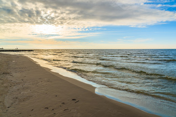 View of Leba beach during sunny day with clouds just before sunset, Baltic Sea, Poland