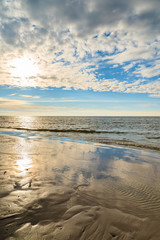 View of Leba beach during sunny day with clouds just before sunset, Baltic Sea, Poland