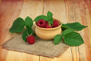 Delicious raspberries on wooden background. Fresh berries.Close-