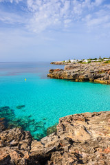 Fototapeta na wymiar View of small bay with turquoise sea water, Menorca island, Spain