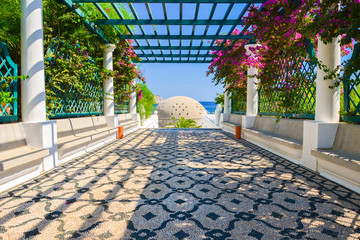 Walkway among tropical plants in gardens of Thermes Kalithea on Rhodes island, Greece