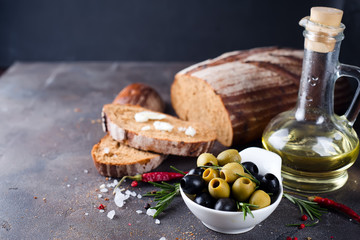 Fresh bread with olive oil and olives