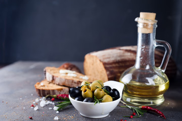Fresh bread with olive oil and olives