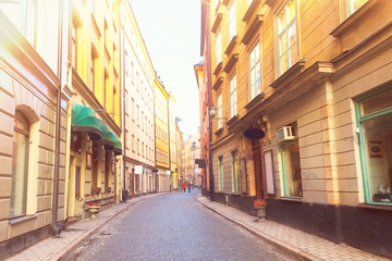 Fototapeta na wymiar old town Gamla Stan street in Stockholm at day, Sweden, retro toned