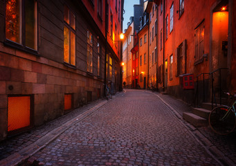 Fototapeta na wymiar Gamla Stan street illuminated at night, Stockholm, Sweden, retro toned