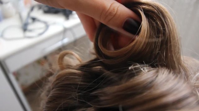 Close up shot of woman's hands. Woman holding case with barrettes in white make up room. Beauty and haircare concept
