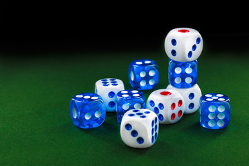 blue and white dices on the green velvet surface