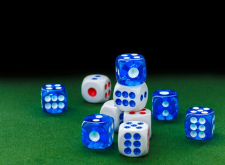 blue and white dices on the green velvet surface