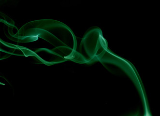 Fototapeta premium Green smoke on black background