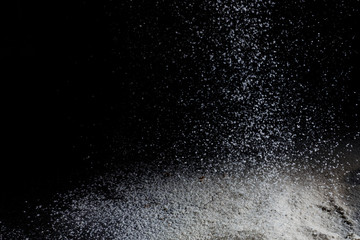 White flour on black backgorund texture photo