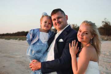Obraz premium happy family watching the sunset on the beach