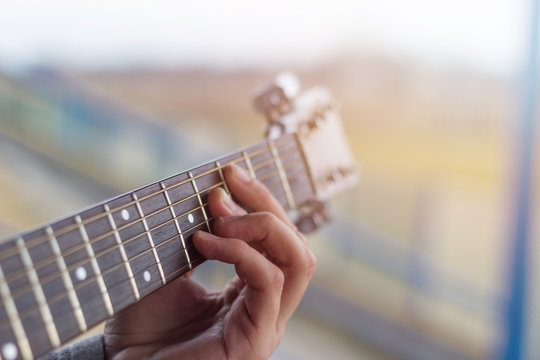 Close-up of men playing acoustic guitar