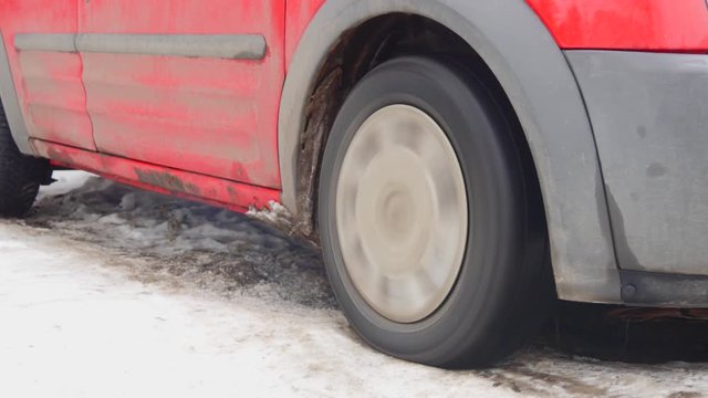 The wheel of the car slips in the snow during heavy acceleration