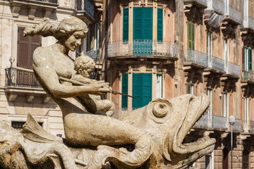 Naklejka premium Old fountain in the historic centre of Syracuse, Sicily island,