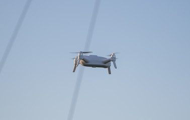 Fototapeta na wymiar A small drone flying in the sky.