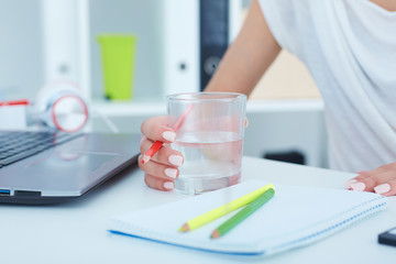 Drinking water while working with laptop computer