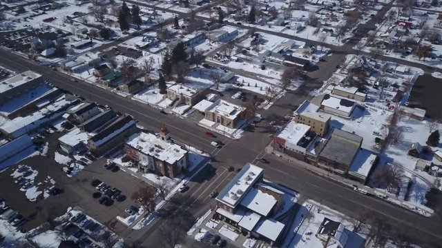 Aerial Ephraim Utah rural city business home street drone. Aerial point of view. Winter storm and blizzard drops over a foot of fresh white snow. Surveillance airborne. Rural farm community.