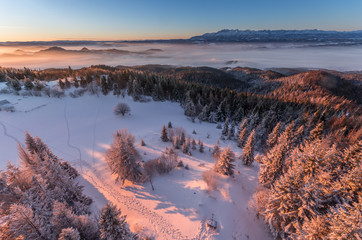 Obraz premium Winter sunrise seen from the snow covered Luban peak, Gorce mountains, Poland