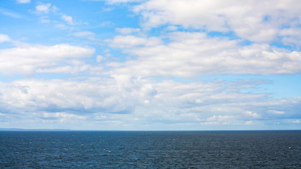 white clouds in blue sky over Baltic Sea in autumn